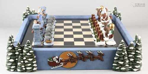 Ceramic Christmas chess with casing and containing a wooden chessboard. Size: 26 x 61 x 61 cm. In