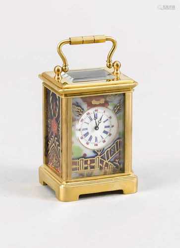 Small gilt brass miniature travel alarm clock with porcelain plaques. 20th century. Size: 6 cm. In