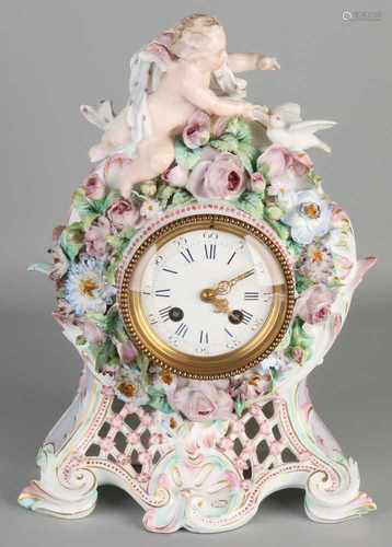 Antique German porcelain clock with reprocessed flowers, angel and dove. Marked with anchor. One