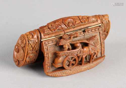 Walnut inserted colonial snuff holder with chariot and horn blowing putti. Verso torch and arrows