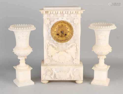 Three-piece Empire alabaster clocks couple. Eight day-movement, half-hour battle, silk suspended