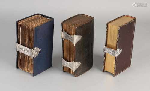 Three Bibles with silver clasp, 833/000. Bible with leather cover with a double lock with engraving,