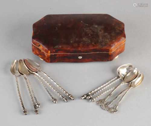 Lid octagonal box of ivory turtle on four paw filled with 12 silver spoons in various models. 835/