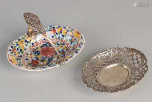 Two sweet boxes with silver 835/000. oval silver bonbon dish with grid decor and floral machining,