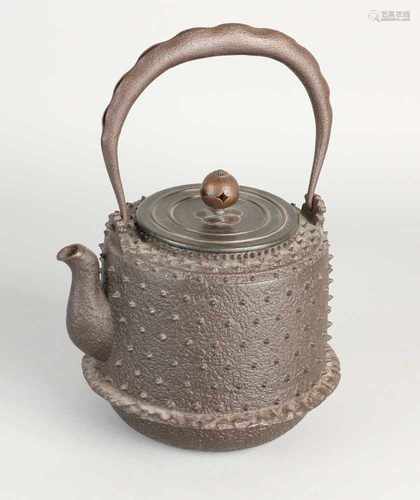 Heavy cast iron antique Chinese teapot with studs. Signed under bronze lid. Size: 16 x 14 cm dia. In