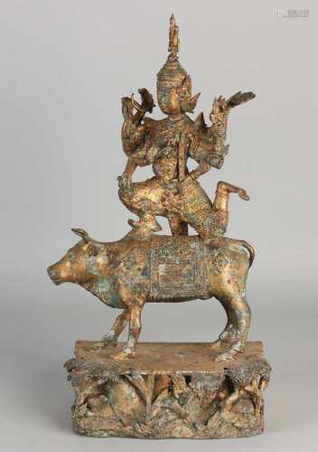 Oriental bronze Buddha figure on sacred bull. 20th century. Size: 38 x 20 x 11 cm. In good