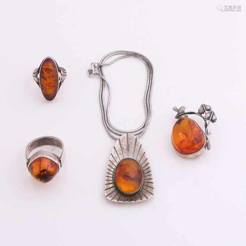 Four silver jewelry with amber. a snake necklace with a triangular-shaped pendant with amber, a