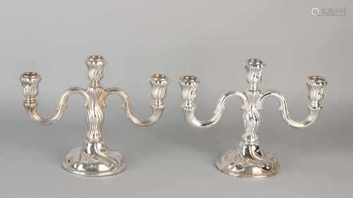 Two silver table candlesticks 835/000, 3 light on a round base with two twisted arms curled. MT .: