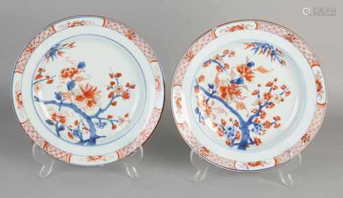 Two 18th century Chinese Imari porcelain plates with blossom branches decor. Some chips. Size: ø