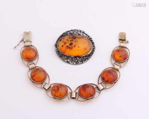 Silver brooch and bracelet with amber. Bracelet, gold-plated, with six oval links set with a round