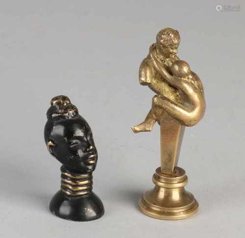 Two ancient bronze briefverzwaarders. One times erotic, circa 1900. One time blacks ladies bust,