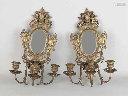 Two antique brass historicism wall candlesticks with putti and faceted mirrors. Circa 1880.