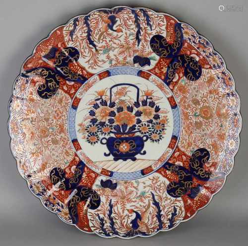 Very large 19th century Imari porcelain decorative plate with floral / gold decor. Molded rim. One