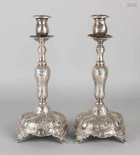 A set of silver candlesticks 800/000, rococo style. Decorated with floral decor twisted. Posted on