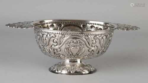 Silver brandewijnkom decorated with floral gear and provided with a crowned shield. With