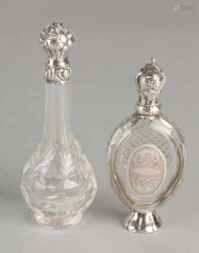 Two crystal loderein vials with silver, 833/000, one oval bottle with silver on silver foot rim,