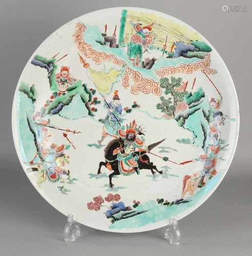 Large Chinese porcelain dish with warriors in ornamental landscape setting. With bottom mark.