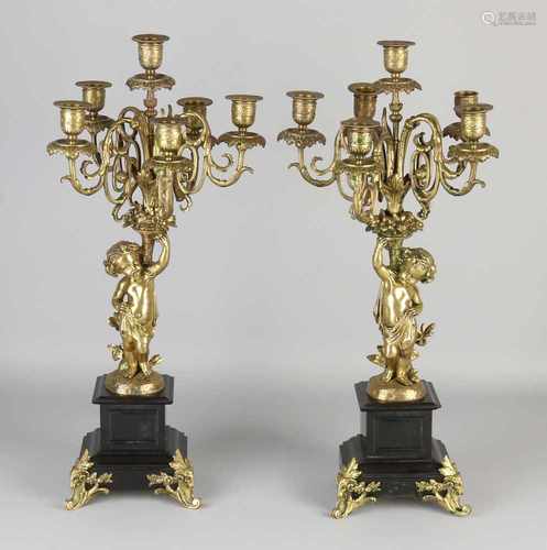 Two antique bronze six-light candle candlesticks with putti and black marble base. Circa 1880.