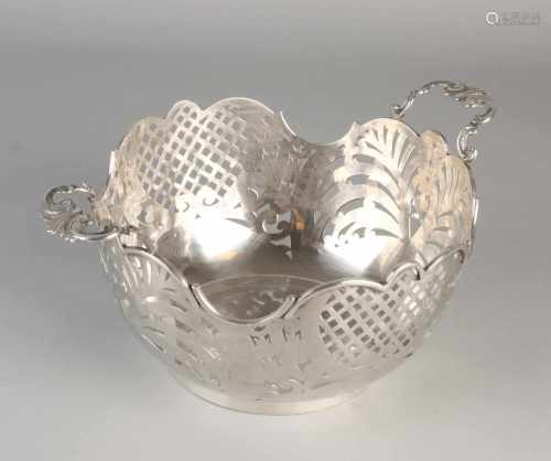 Handmade silver puffs basket, 900/000, placed around model with sawn operation on a circular ring.