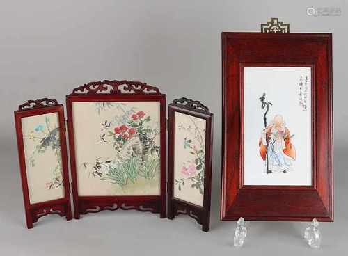 Twice ancient China. 20th century. One three-piece carved screen with silk paintings. One