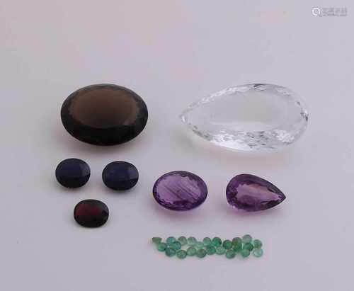 Lot gems: a large rock crystal, pear-shaped, 125,8ct, smoky quartz, oval faceted, 70.54 ct, 2