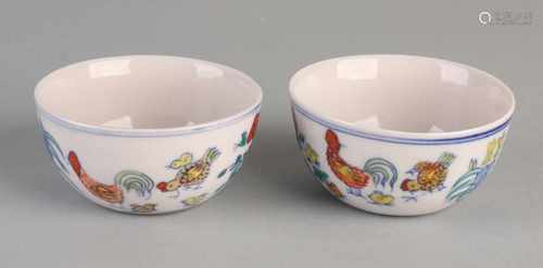 Two Chinese porcelain cups with chicken decor and text. With bottom mark. Size: 4 x ø 8 cm. / Ø 3.