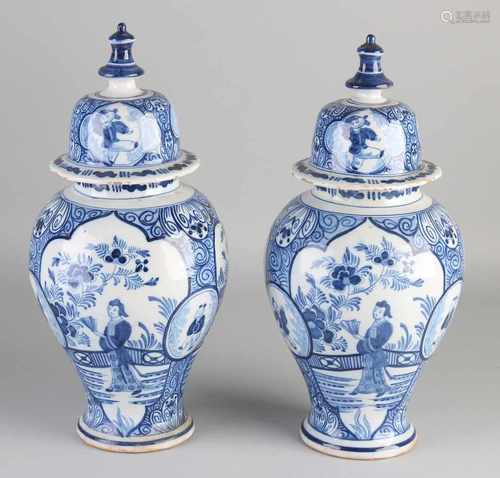 Two 18th century Delft Fayence covered vases with chinoiserie decoration and zotjes. Marked with