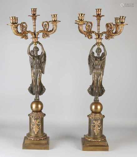 Two capital French Empire bronze candle candlesticks with angels. Two-colored patina. Circa 1820.