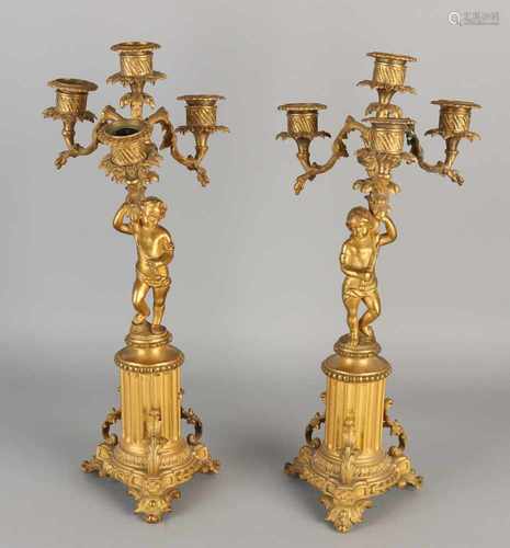 Two French ormolu bronze candle candlesticks with putti. One repair. One Candlestick bent