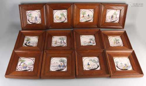 Fate of 12x 19th century hollandse colored wall tiles in oak lists, with figures in