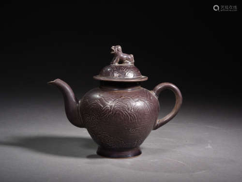 A Chinese Purple Carved Porcelain Pot with Handle