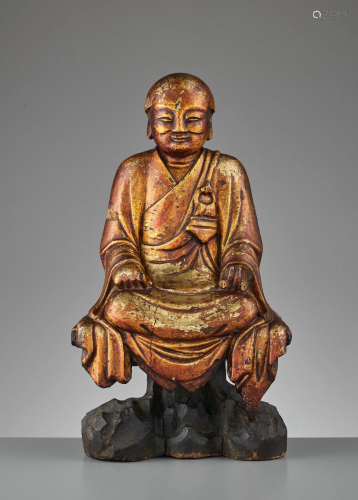 A GILT WOOD STATUE OF A LUOHAN, MING DYNA…