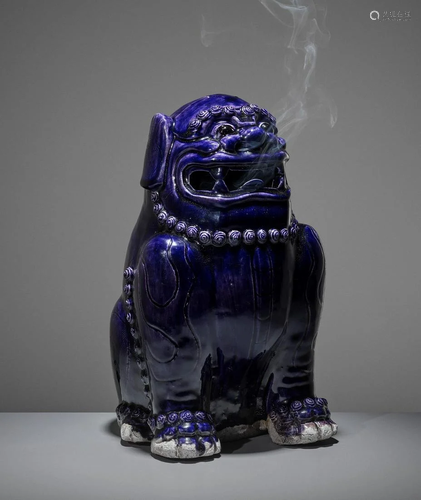 A LARGE AUBERGINE-GLAZED BUDDHIST LION, KA…