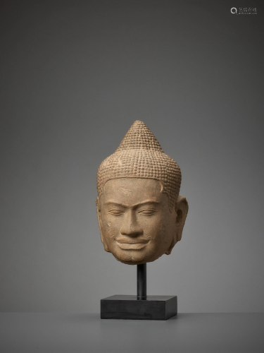 A BAYON STYLE LIFESIZE HEAD OF BUDDHA LATE 12TH…