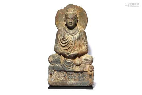 A CARVED GREY SCHIST FIGURE OF A SEATED BUDDHA