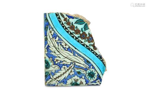 A FRAGMENT OF A RED-PAINTED IZNIK POTTERY TILE