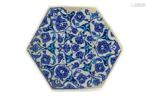 A BLUE AND WHITE HEXAGONAL IZNIK POTTERY TILE