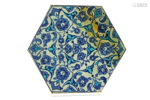 A BLUE AND WHITE HEXAGONAL IZNIK POTTERY TILE