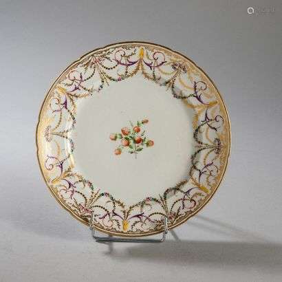 BORDEAUXPorcelain plate with contoured rim with polychrome decoration of strawberries in the center and garlands of flowers and foliage on the wing.Marked: W in gold.Manufacture of Verneuilh and Vanier.18th century. Diameter : 24 cm