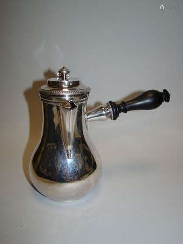 Silver coffee pot. PARIS, F. A. BOULENGER, 1819-1838. Plain model with flat protruding bottom. Ebony side handle turned into a swollen disc sleeve. Fluted spout and domed lid. Body bordered at the neck with a beaded frieze. Scroll and shell thumb rest. Lid with protrusion and knob, bordered by a wavy frieze. Monogram and inscription engraved under the bottom: PC / 400 gmes.Some shocks, depression of the thumb rest scroll and twisted circular base.Top. : 17 cm ; Gross weight : 419.9 g.