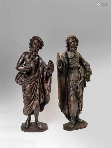 Saint Jerome and an apostle.Oak wood sconce statuettes,Jerome is presented as a penitent in the desert, naked and draped in a coat, beating his chest with a stone. The apostle, barefoot, is dressed in a long robe with a large flap collar, he holds an open book against his left hip and the dexter raised, which must have had a missing attribute. North East of France, mid 17th century. High. 73 cm high (Some accidents and restorations)