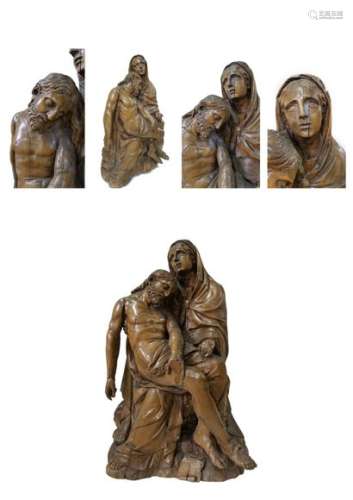 FRENCH school from the end of the 17th century. Group of PietàSculpture in hardwood, slight traces of coating and polychromy, hollow back. The Virgin, with her face raised towards the sky, her left hand open palm upwards, holds the body of her dexter son under Christ's right shoulder in a seated position and whose head leans over his mother's chest. The left hand repeats the gesture spread by Michelangelo's Pietà, while the face raised towards the sky marks the evolution of the Baroque Pietàs from the mid-17th century onwards. Some restorations and accidents. Top. :86 cm - Width : 48 cm