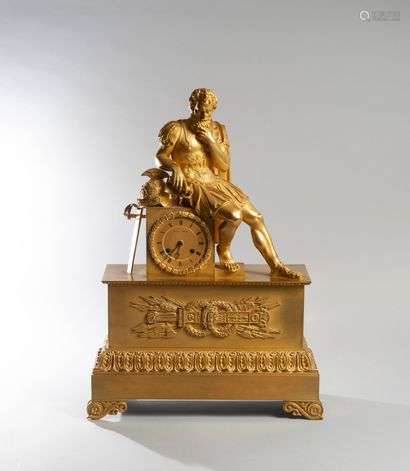 A chased and gilded bronze clock with a figure of Mars in armour seated on a bollard encircling the dial surrounded by a laurel wreath.Rectangular base decorated with a frieze of acanthus leaves and a trophy of javelins and quivers.Empire period.High. : 61 cm - Width : 41 cm - Depth : 15 cm.(the shield is missing)