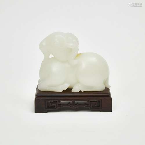 白玉臥羊 A Carved White Jade Recumbent Ram with Stand