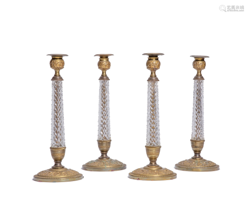 A set of four French bronze and glass candlesticks