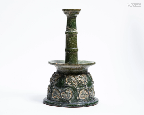 A Middle Eastern green glazed pottery candlestick