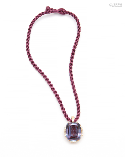 A synthetic sapphire, diamond and gold pendant