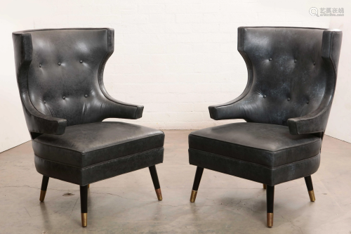 A pair of leather wingback armchairs