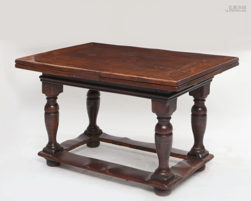 A Baroque style oak draw leaf low table