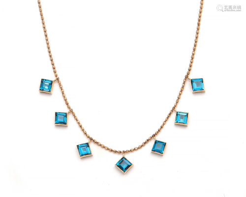 A blue topaz and 18k gold necklace